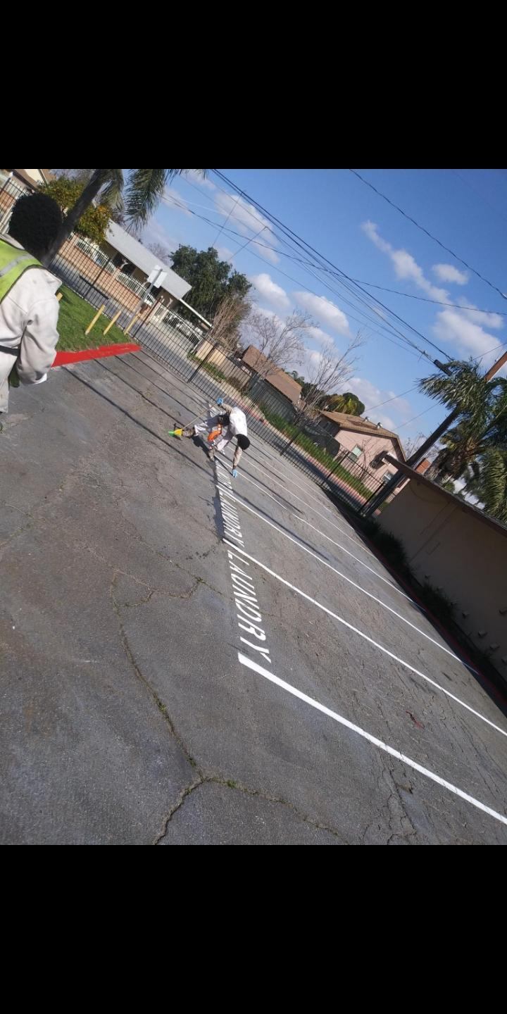 Professionally Line Striped Parking Spaces and Stenciling at an Apartment Complex in Riverside, California.